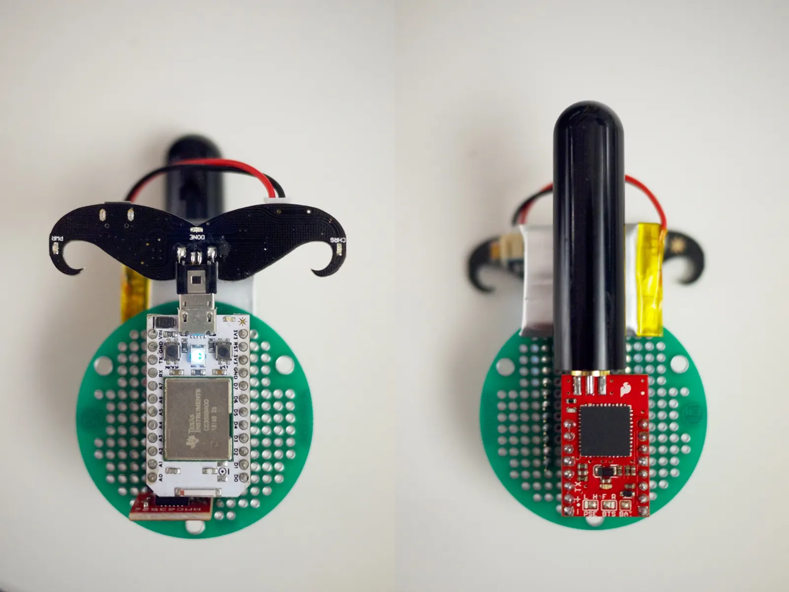 Two round green circuit boards with black mounting brackets, one holding a silver module and one a red module with black tube.