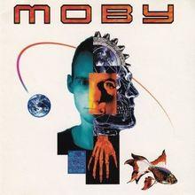 Album cover with the word "MOBY" in red letters above a collaged face split into color panels, with a globe, hand and fish.