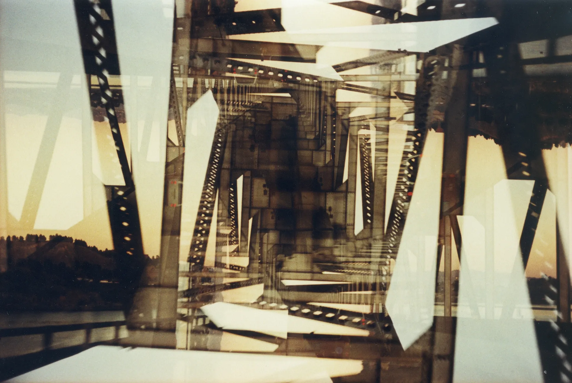 Multiple-exposure photograph layering film strips and sprocket edges into a chaotic sepia-toned abstract collage.