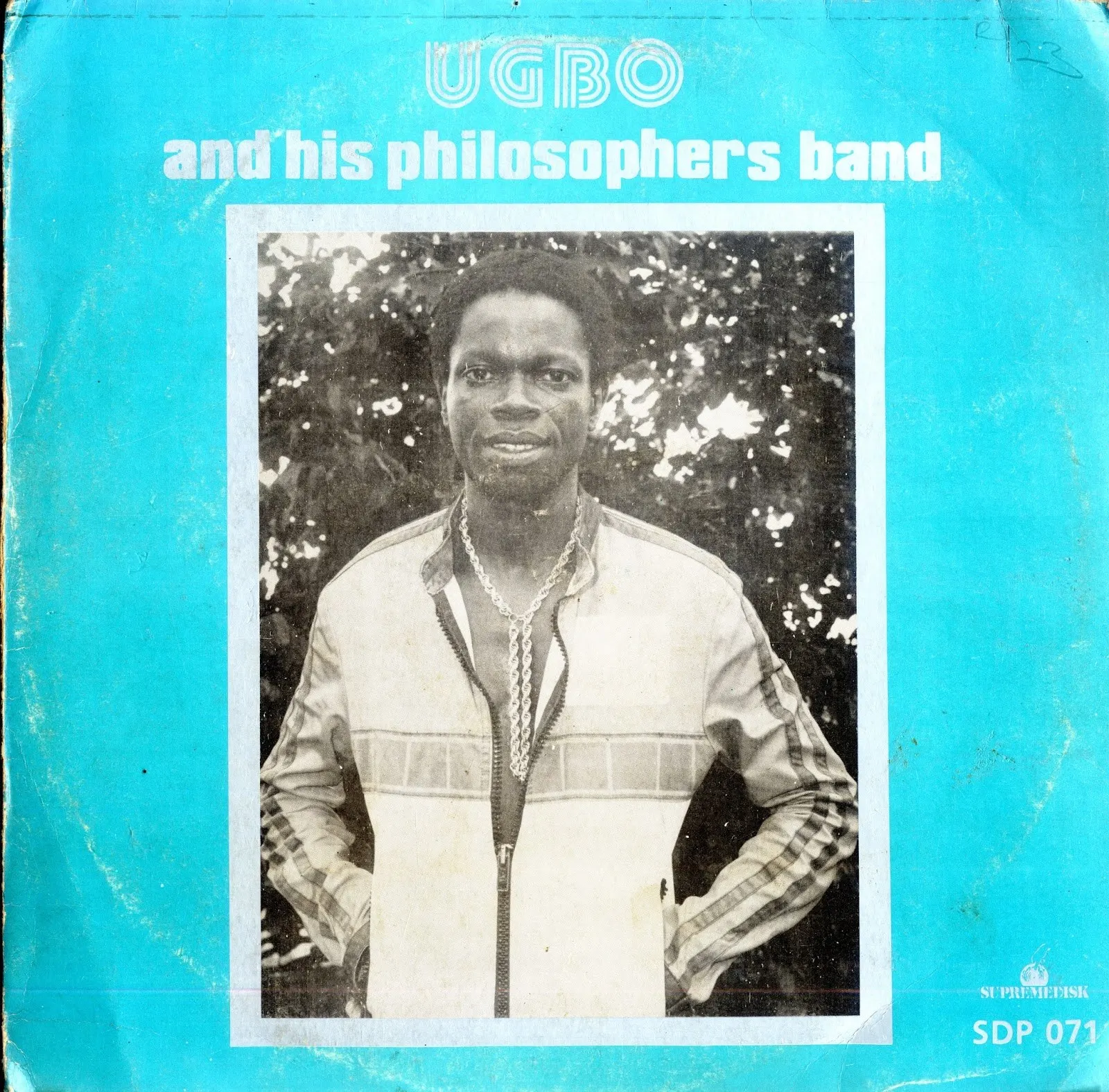 Turquoise record sleeve reading "Ugbo and his Philosophers Band" with a black-and-white photo of a man standing outdoors.